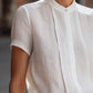Structured Short Sleeve Stand Collar Blouse With Pleated Front Panel